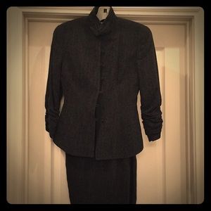 Suit with backslit skirt